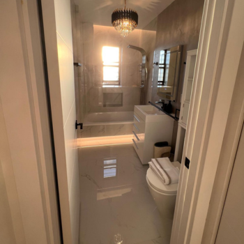 Modern Brooklyn apartment bathroom featuring sleek tiles, a spacious shower, and elegant fixtures, remodeled by Top Iconic Contractors, expert remodeling contractors in Brooklyn