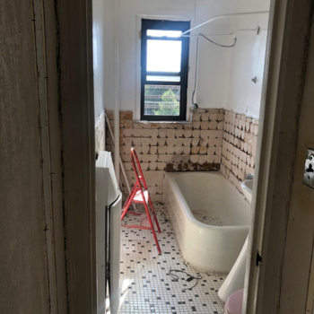 Outdated Brooklyn apartment bathroom ready for transformation, highlighting the potential for expert upgrades by Top Iconic Contractors, trusted remodeling contractors in Brooklyn