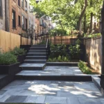 Beautifully designed hardscape in Brooklyn featuring retaining walls, paver walkways, and lush greenery—expertly crafted by local hardscape contractors